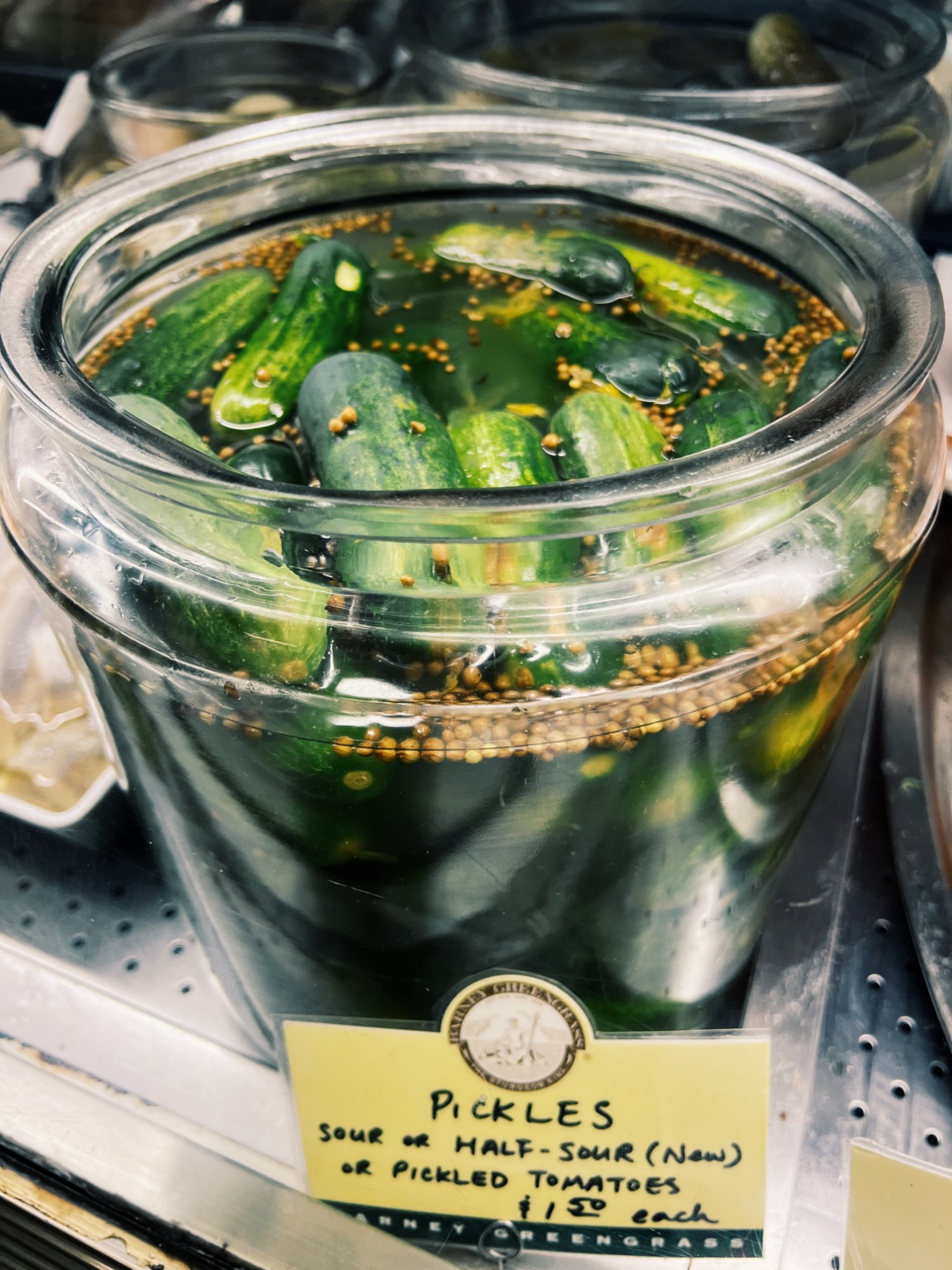Half sour pickles in a jar at Barney Greengrass