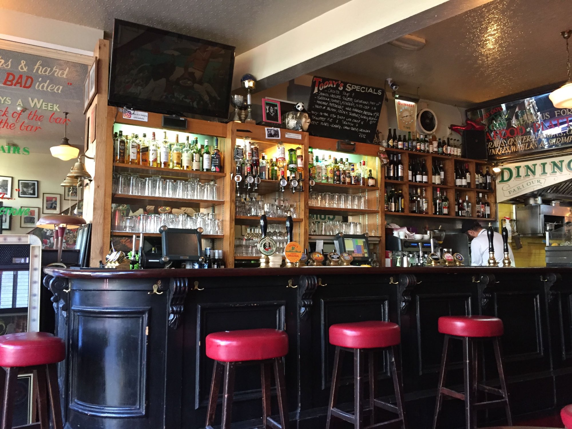The Cow bar interior with red stools and tap handles