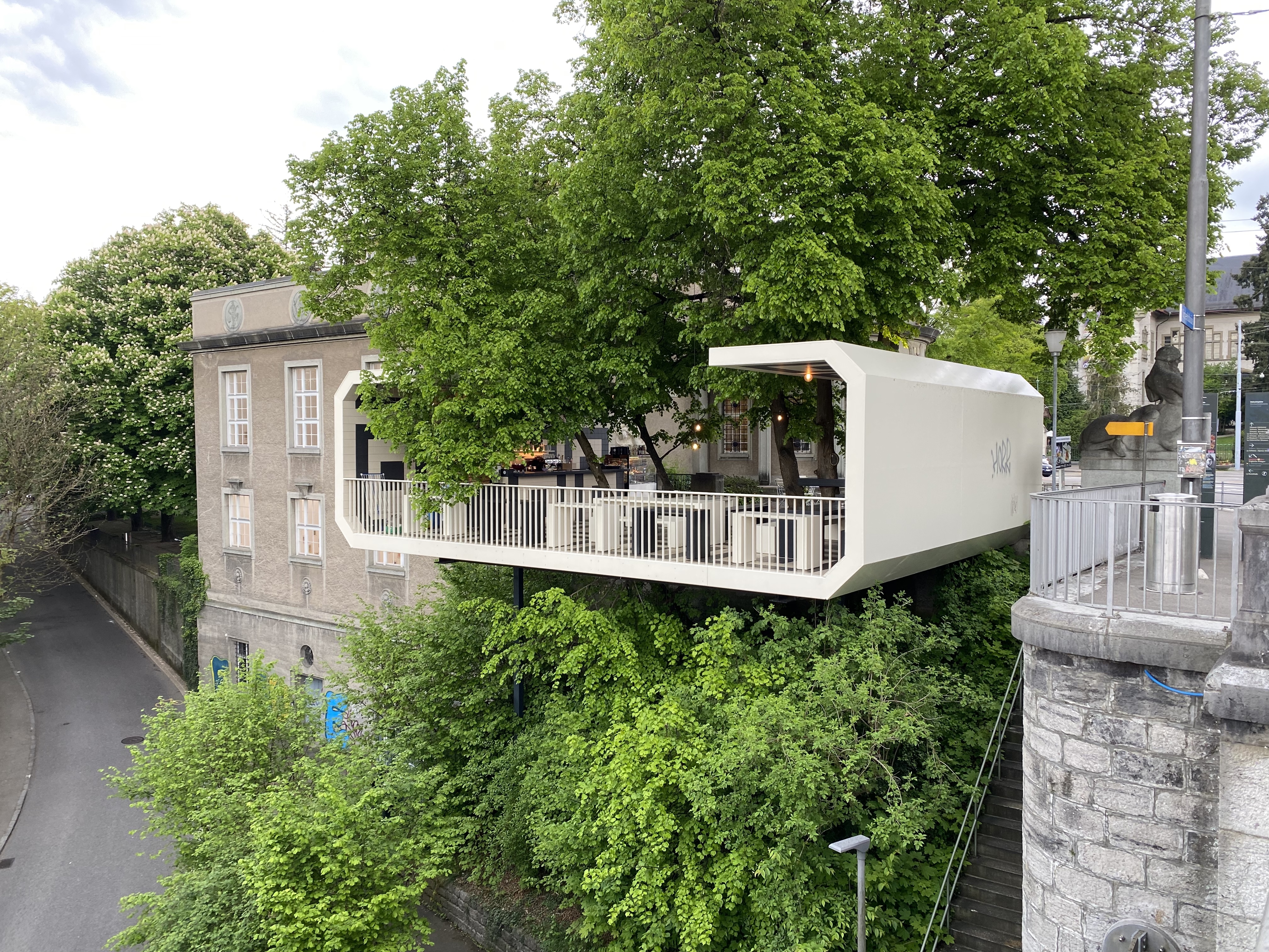 Kunsthalle Bern café — white cantilevered bar over trees, Helvetiaplatz