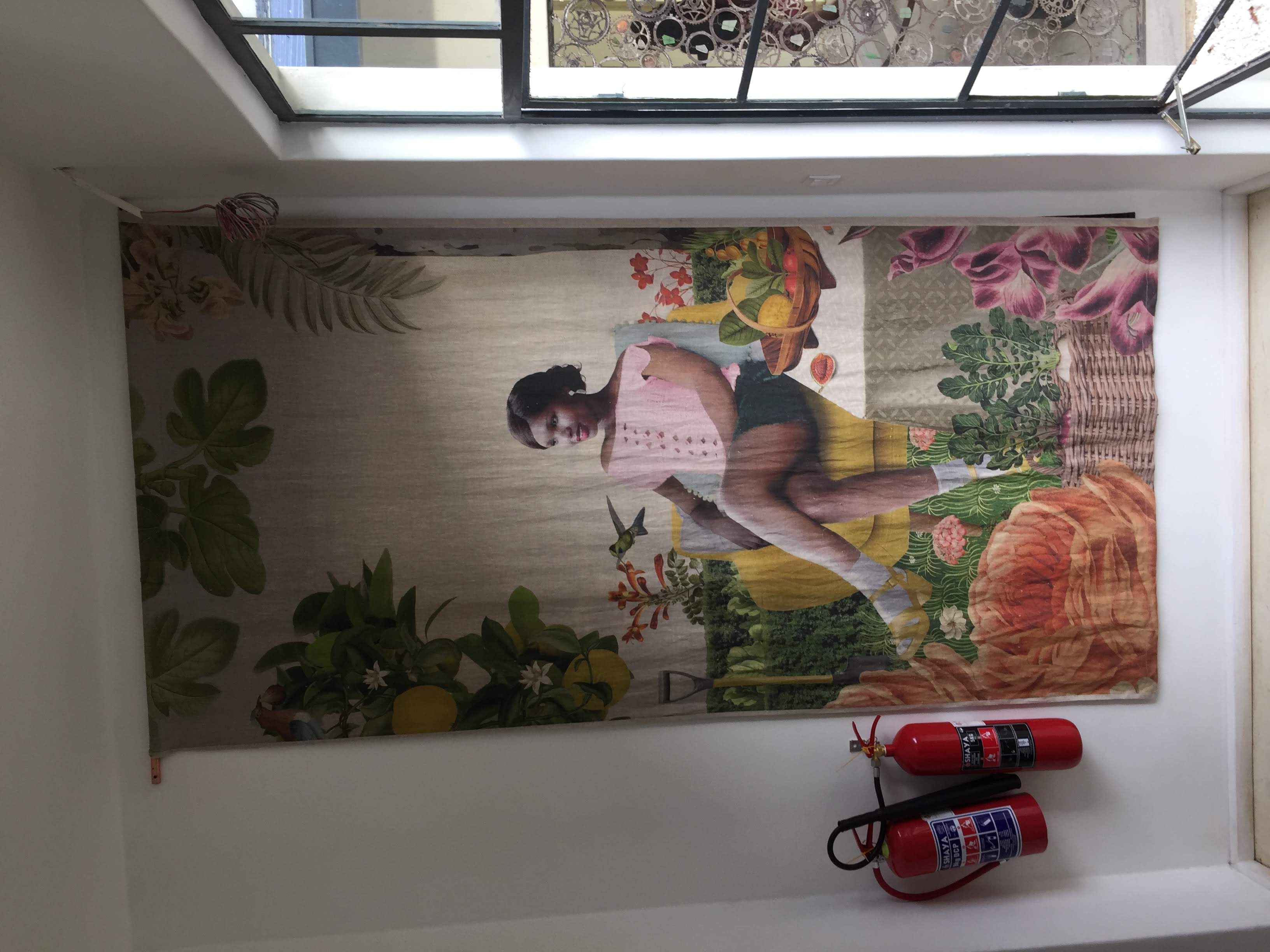 Large textile wall hanging showing a woman in a lush botanical garden — African contemporary art at Latitude 15