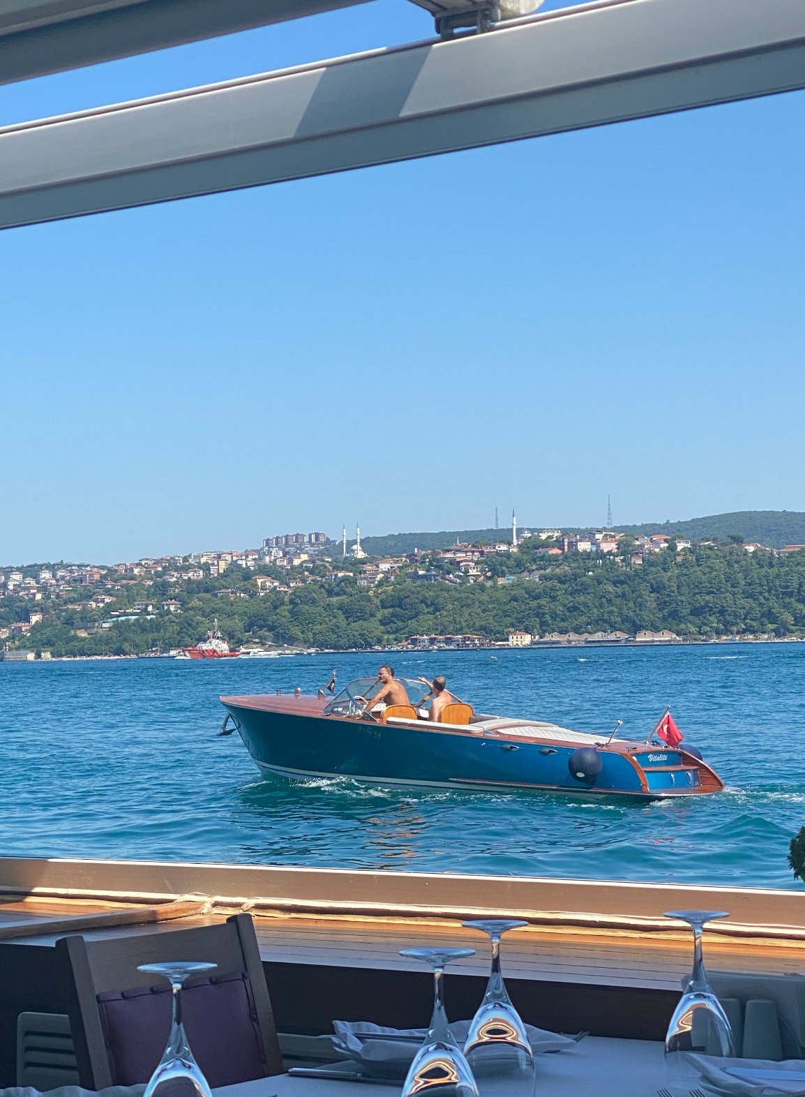 View from the table — wooden boat on the Bosphorus