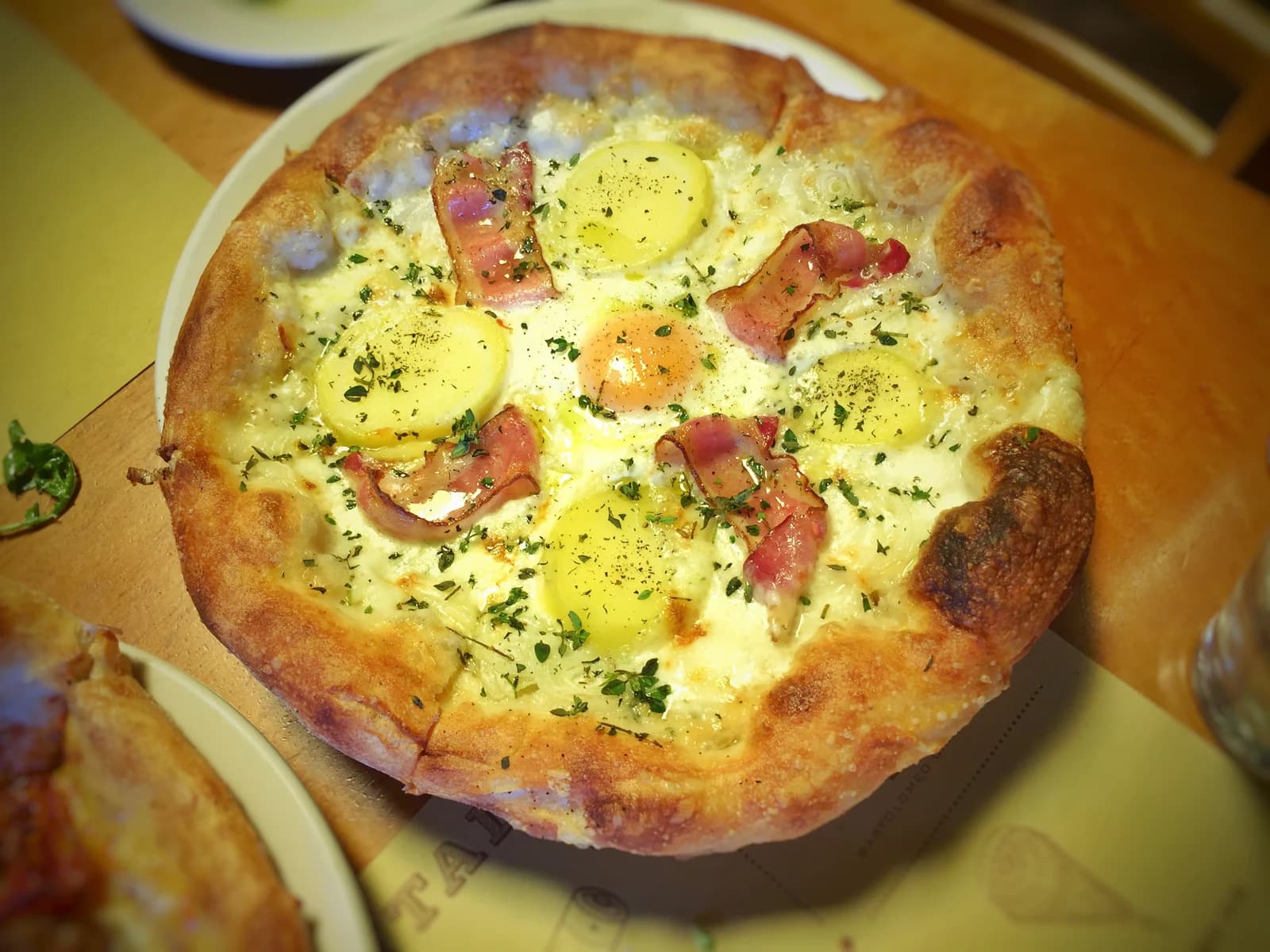 Egg, bacon, Yukon Gold potato and Bermuda onion pizza at Pizzeria Mozza in Los Angeles