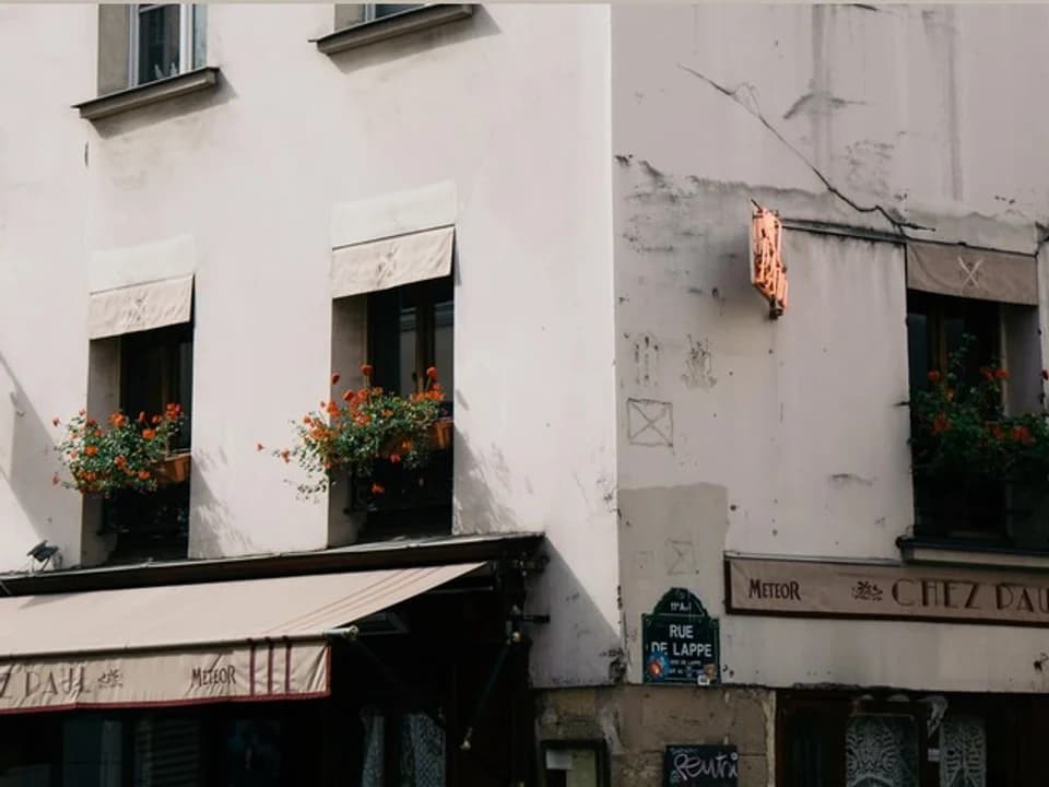 The white facade and awning of Chez Paul on rue de Charonne