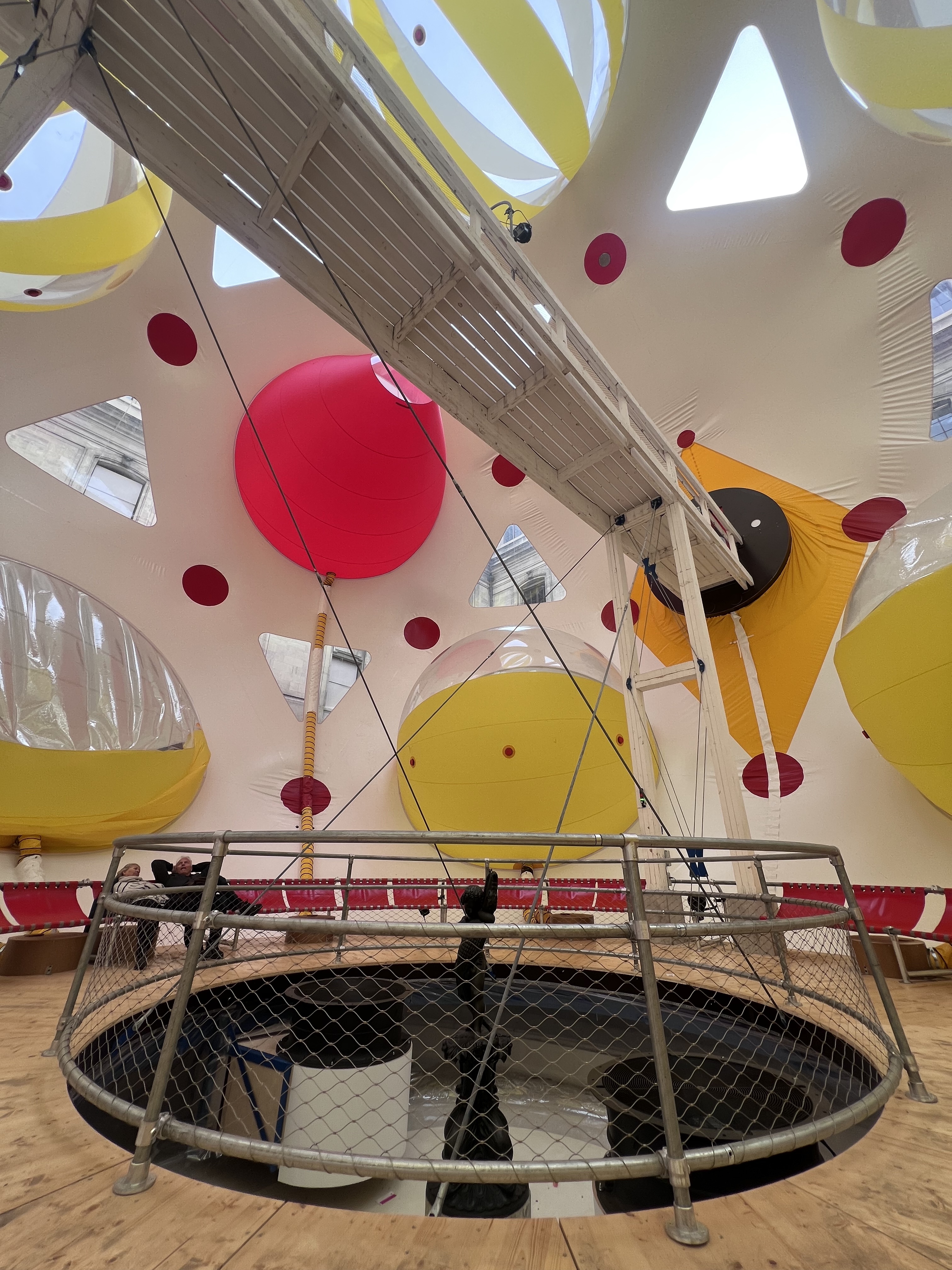 Inside the inflatable bubble at MAH Geneva — yellow and pink shapes, circular platform