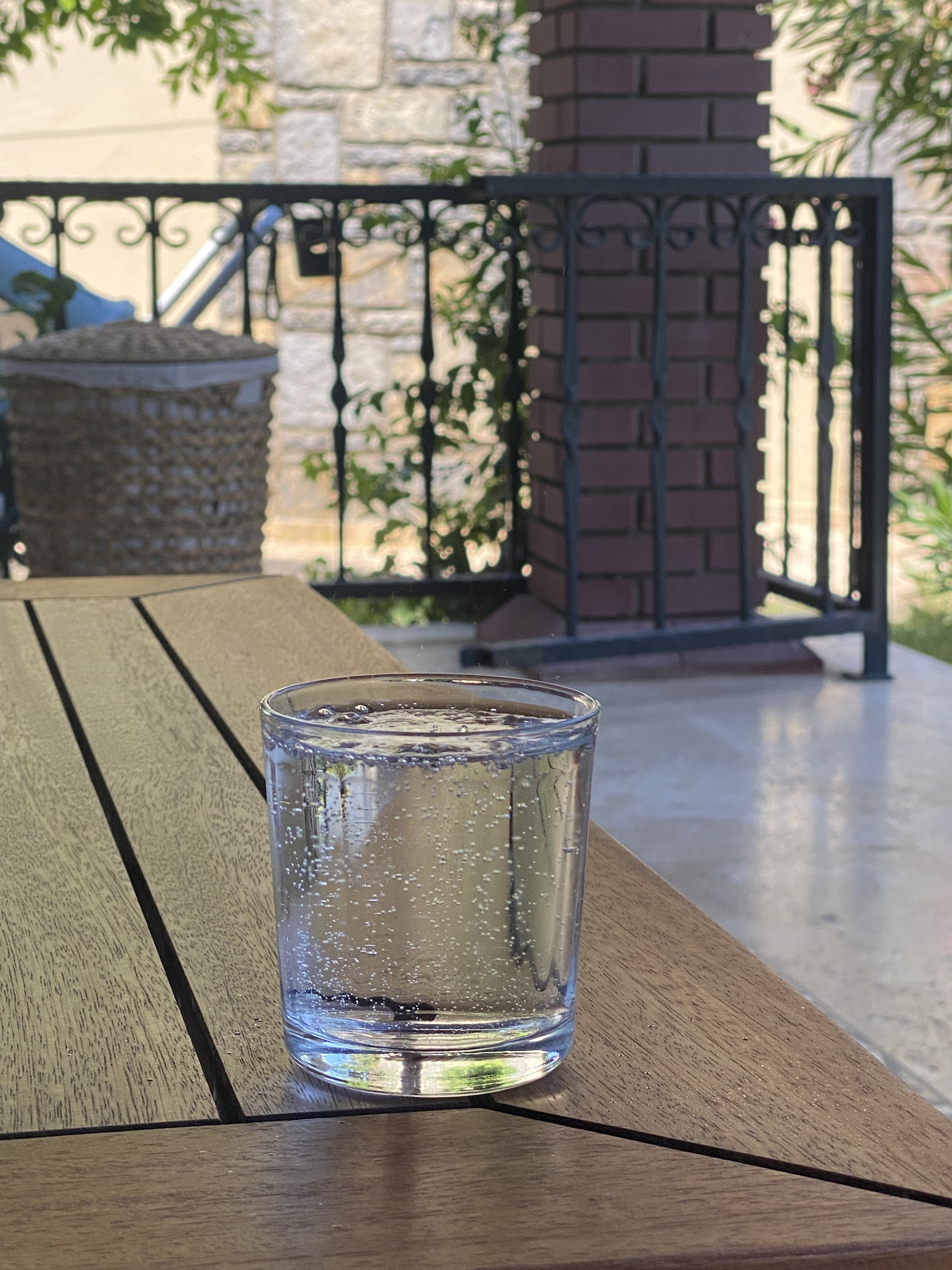 Beypazarı sparkling water poured into a small glass on a wooden terrace table