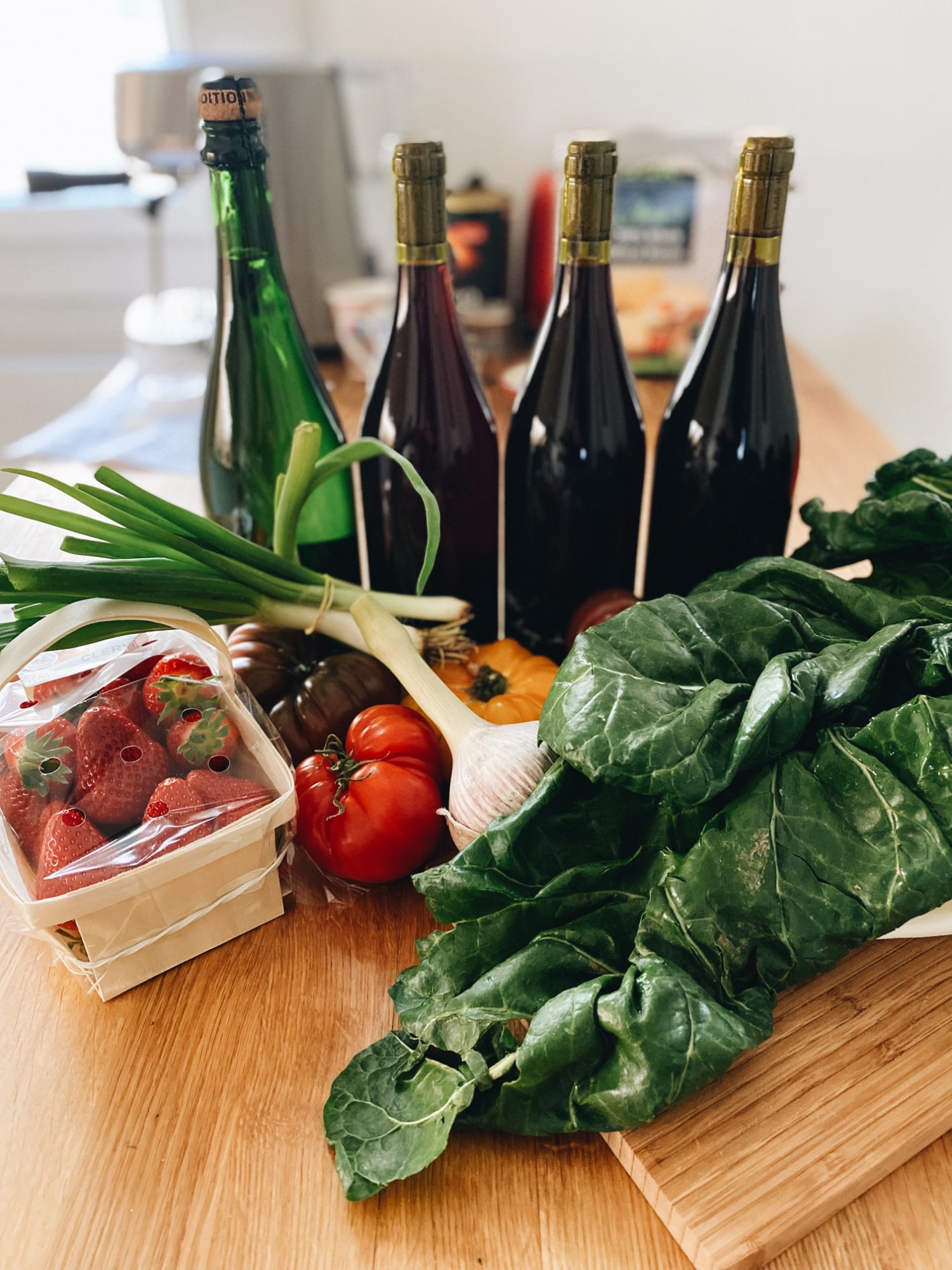 A Saturday market haul — strawberries, chard, and several Paul-Henri bottles