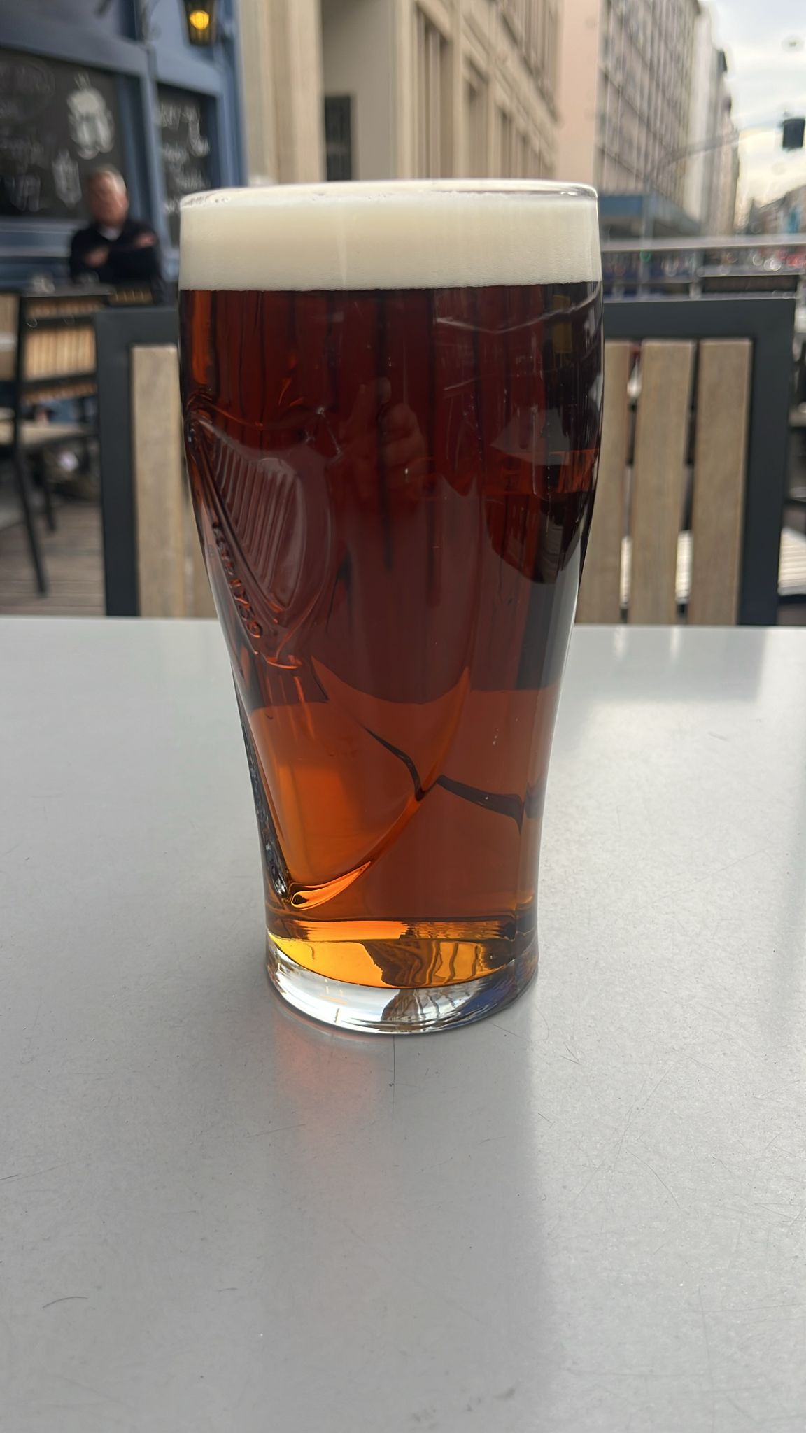 A pint of Murphy's Irish Red on a metal table outside Mr. Pickwick Pub Geneva
