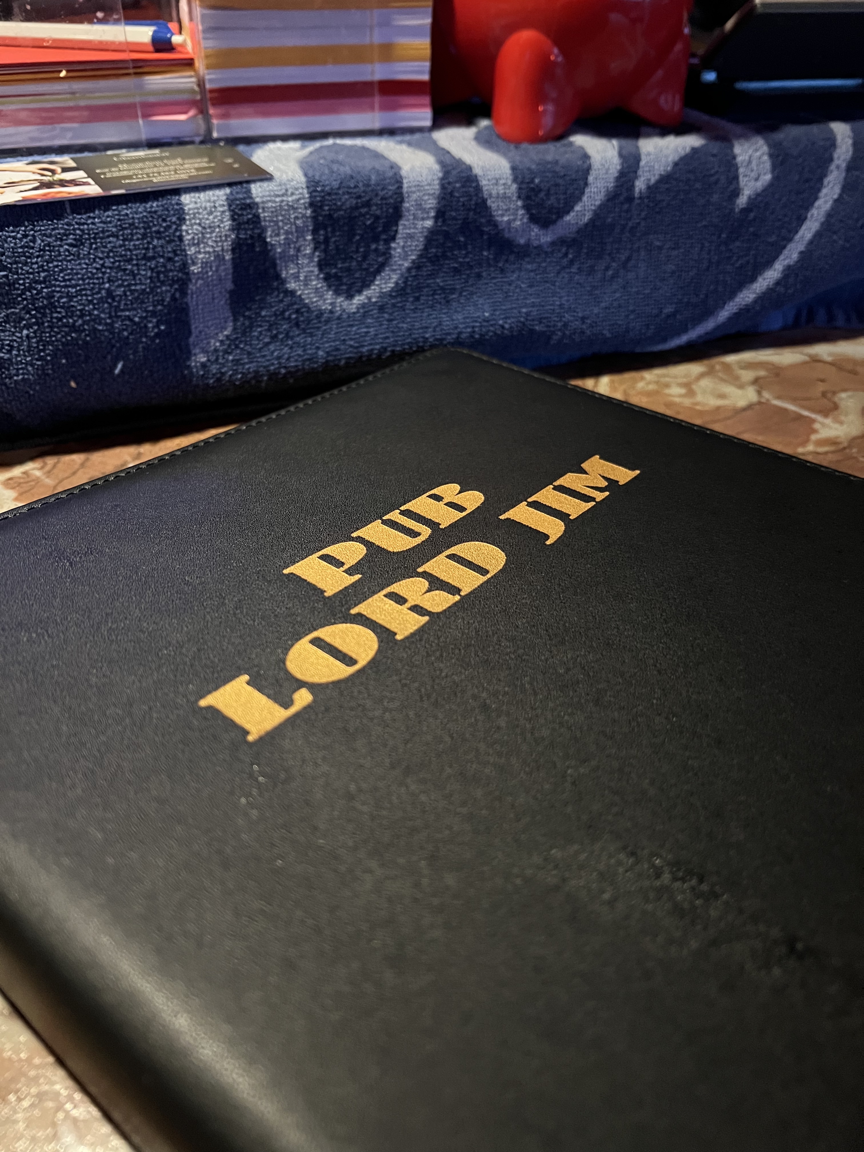 Pub Lord Jim menu cover in gold lettering on black leather