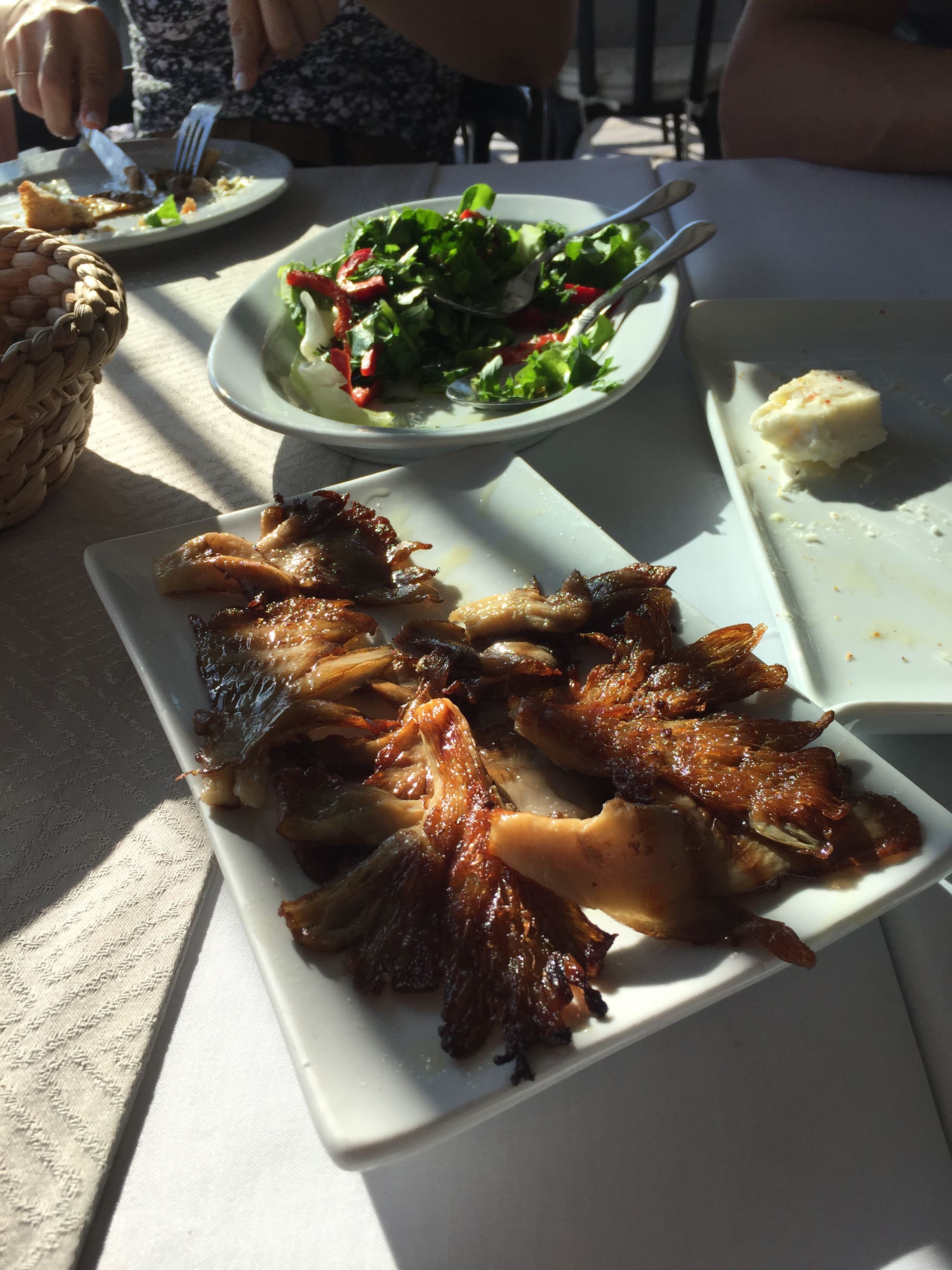 Crisp roasted oyster mushrooms on a long white plate at Filinta