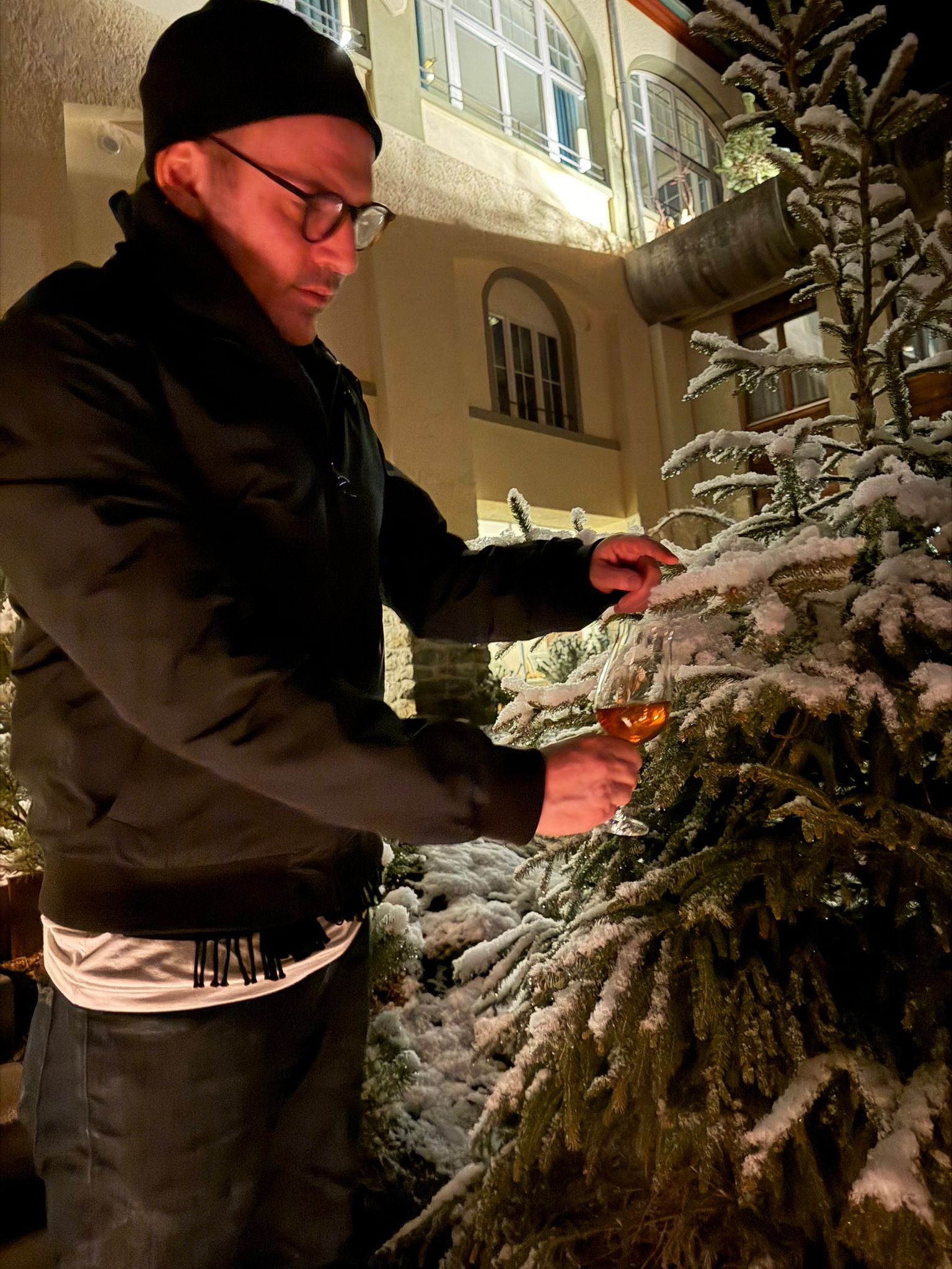 Outside the Belvedere in the snow with a wine glass at night
