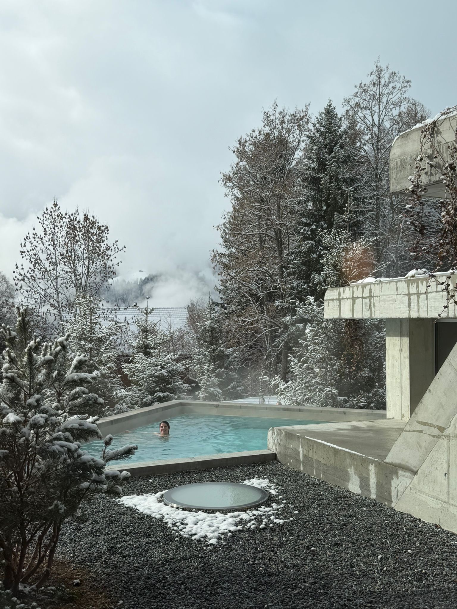 Outdoor heated pool at Grand Hotel Belvedere in winter snow, Wengen Switzerland