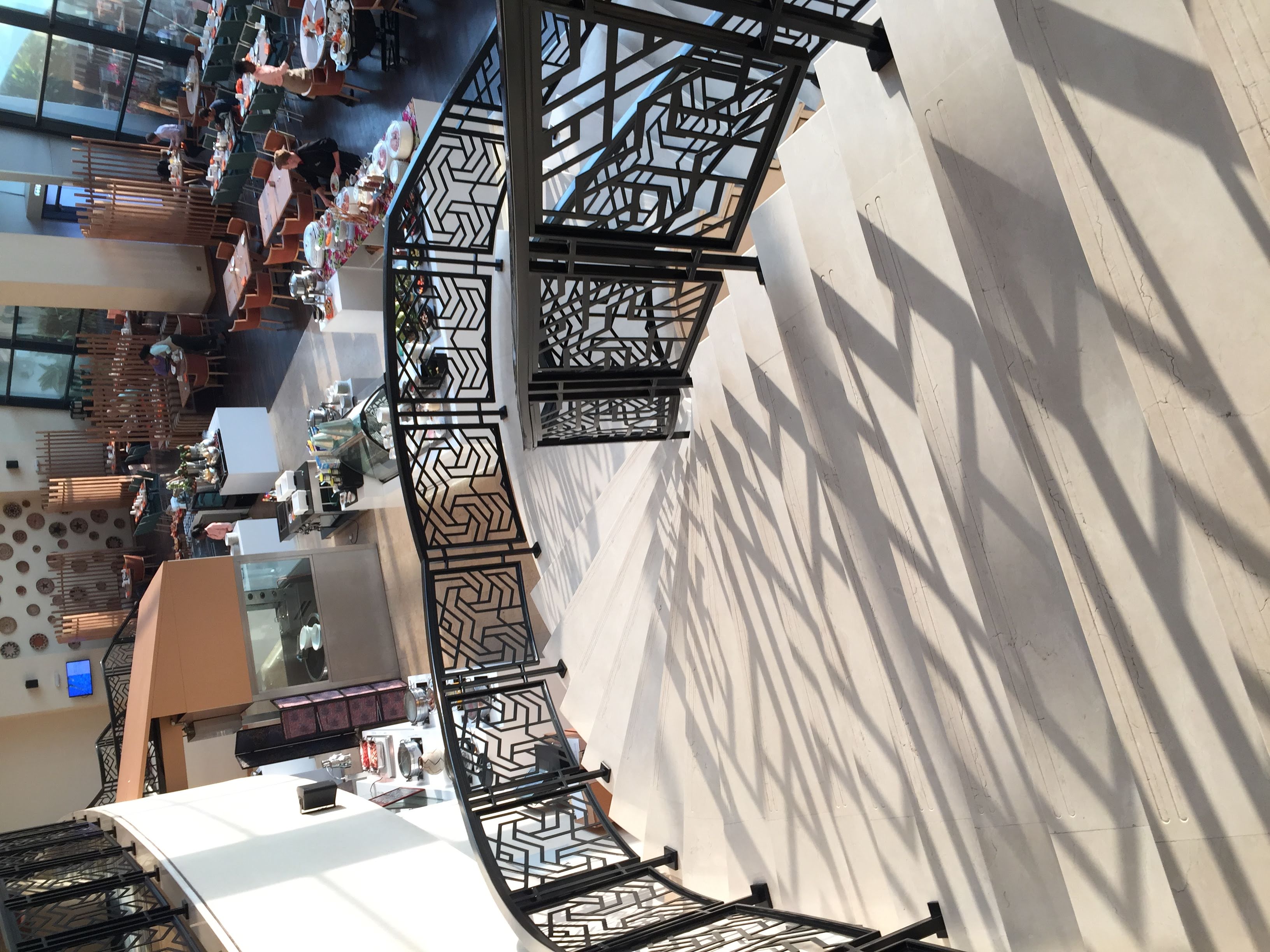 Kigali Marriott breakfast room — grand staircase, morning light flooding in
