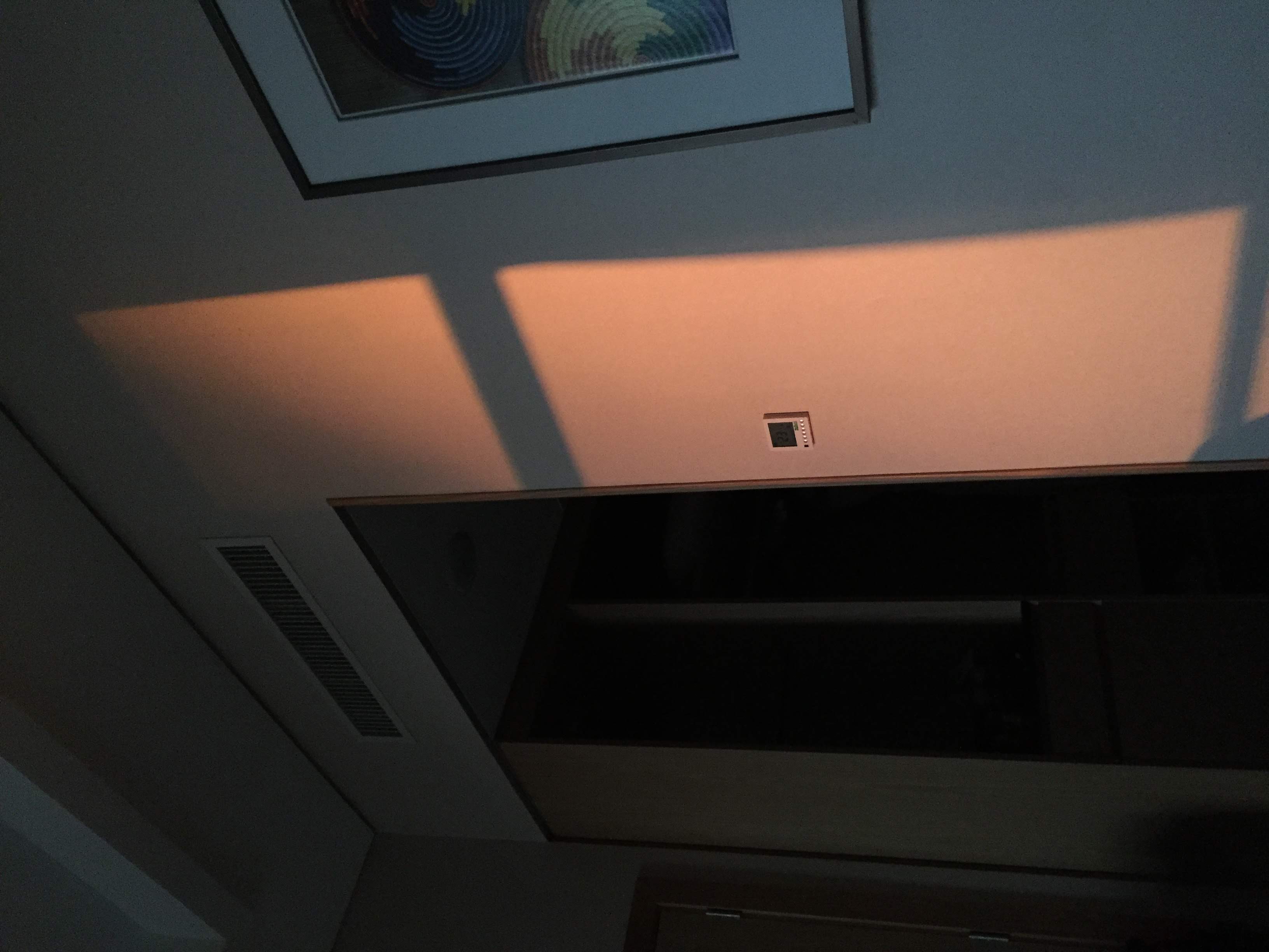 Morning light across the wall of a Kigali Marriott room — abstract, warm