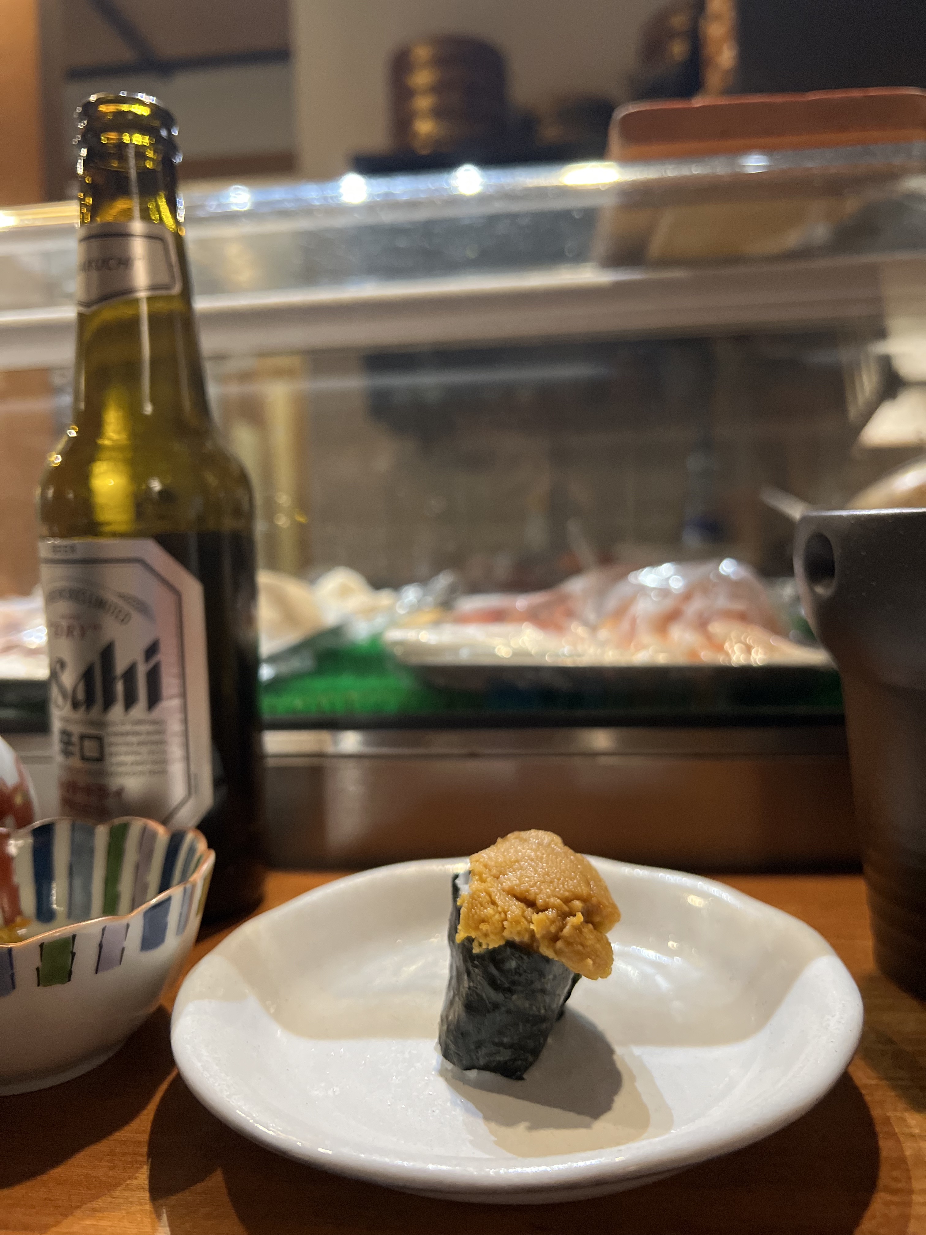 Uni nigiri at Nagomi, Geneva — cold sake alongside