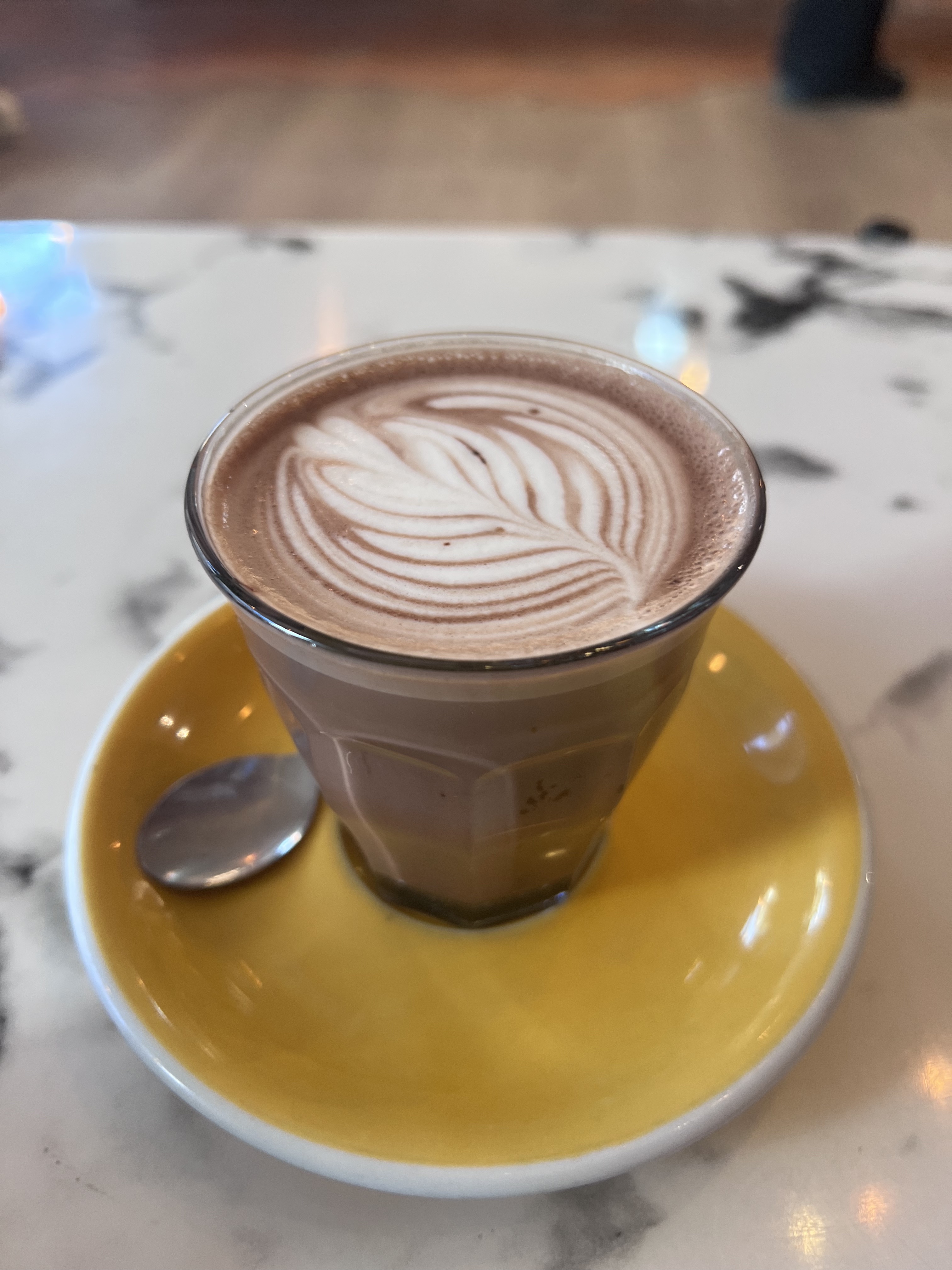 Oh Martine! hot chocolate on yellow saucer, marble table