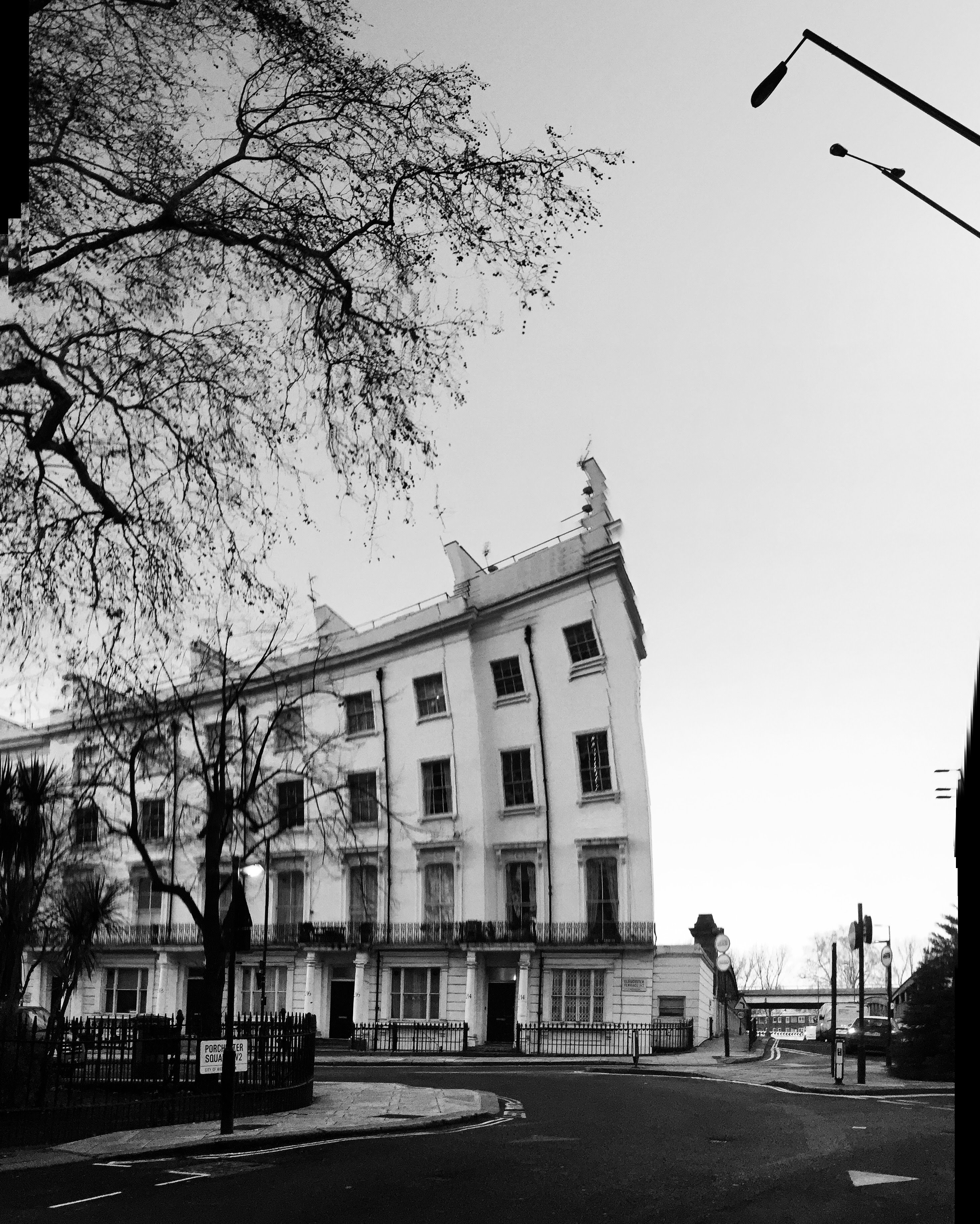 Porchester Square, Bayswater W2, black and white panorama, stucco building at corner