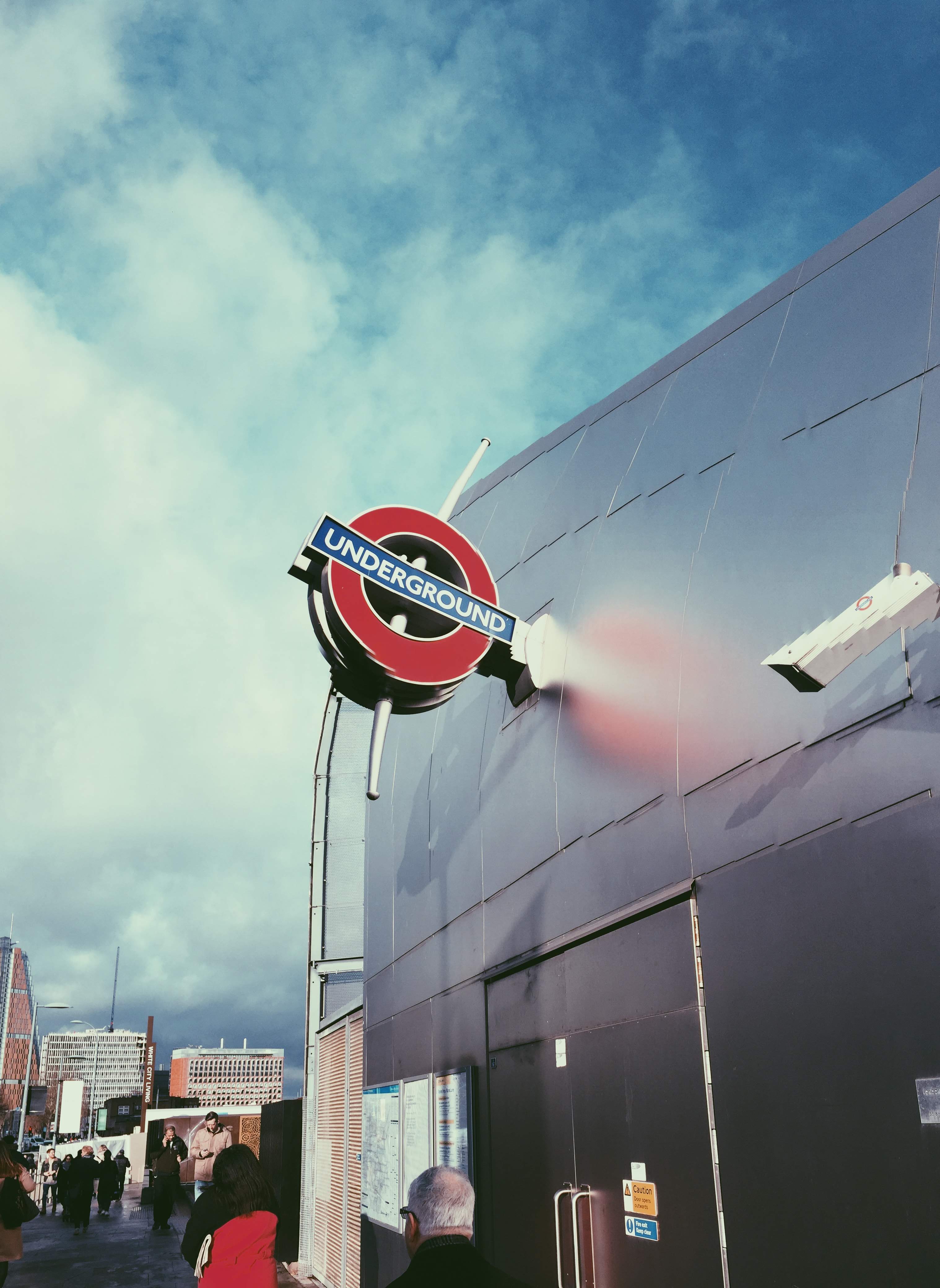 London Underground roundel sign, low angle, panorama distortion, dramatic sky