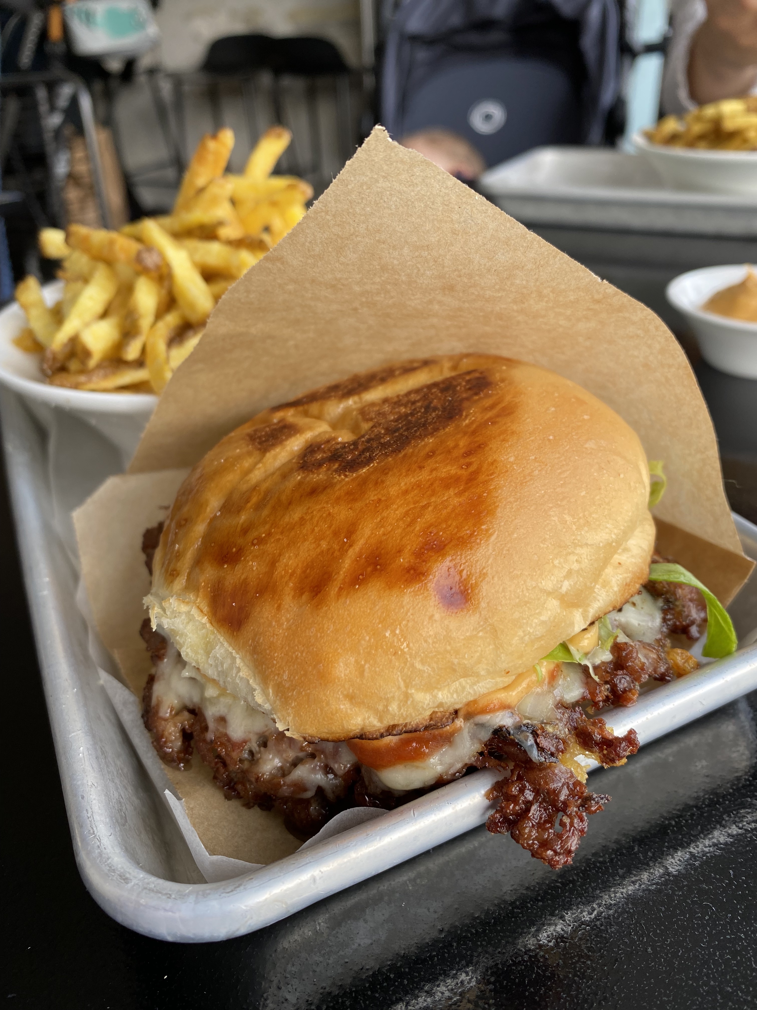 Papabou smashburger close-up — brioche bun, cheese, bacon