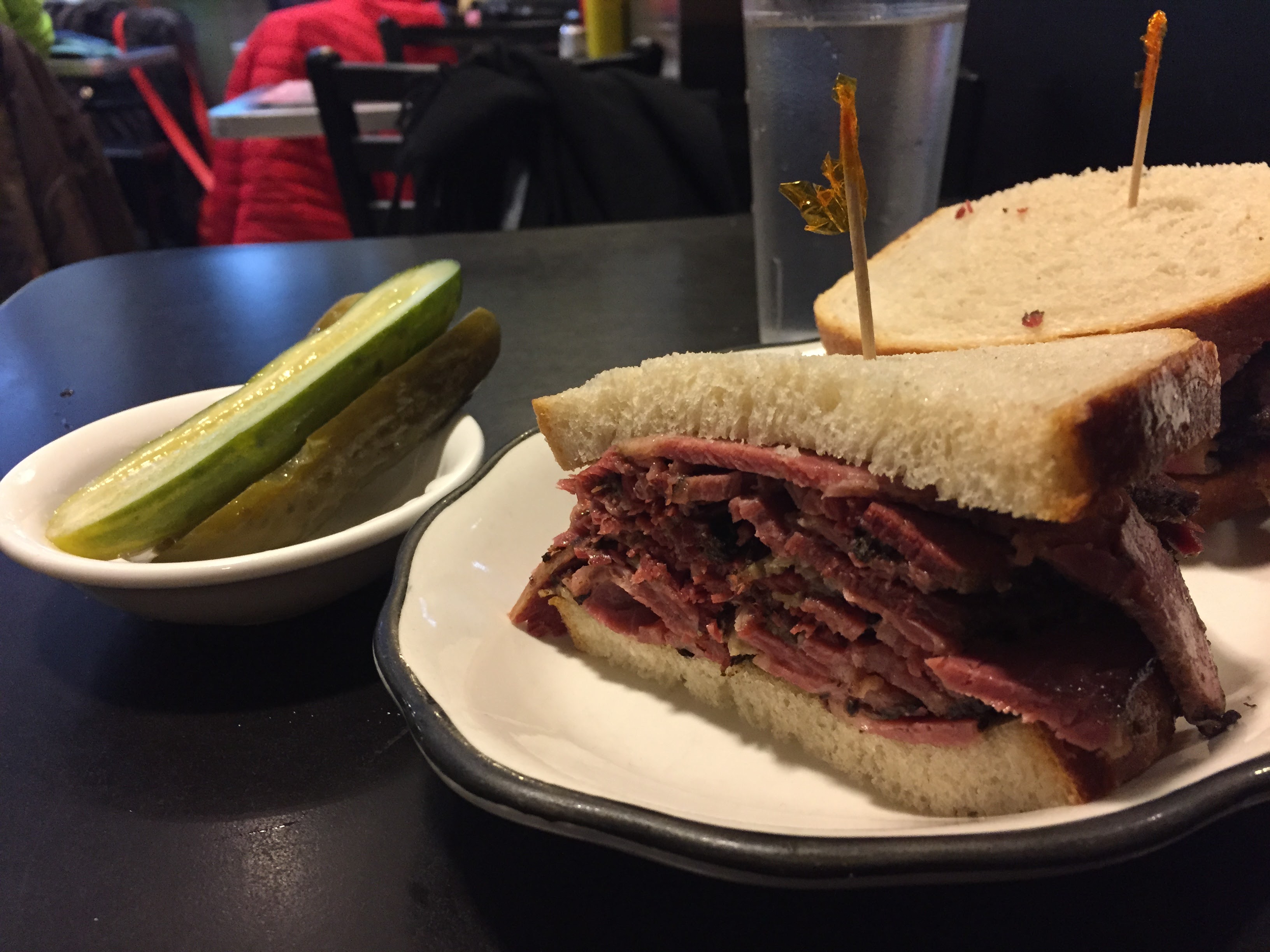 Close up of Pastrami Queen pastrami sandwich — spice crust and fat