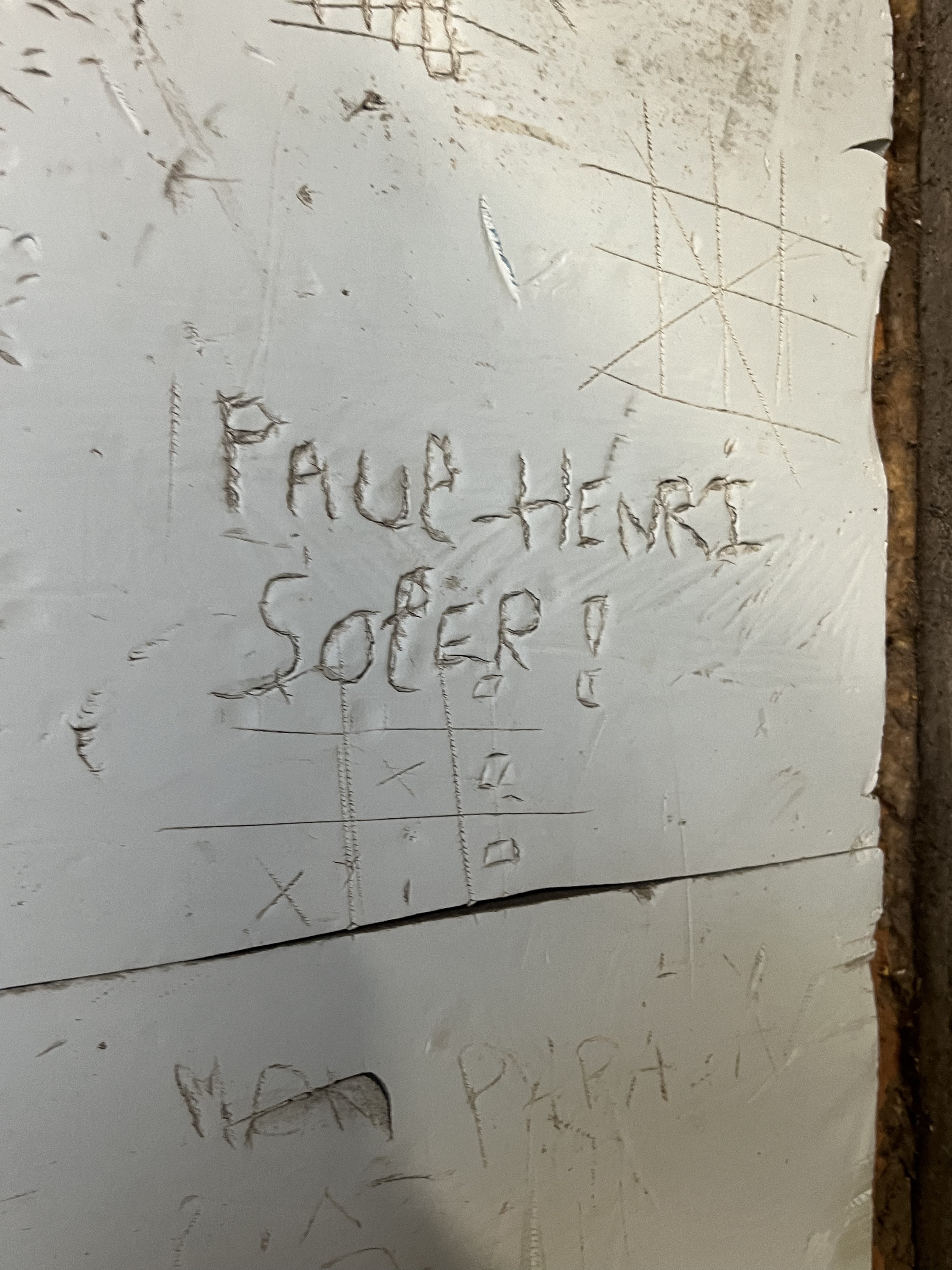 Paul-Henri Soler's name scratched into the plaster wall of his cave