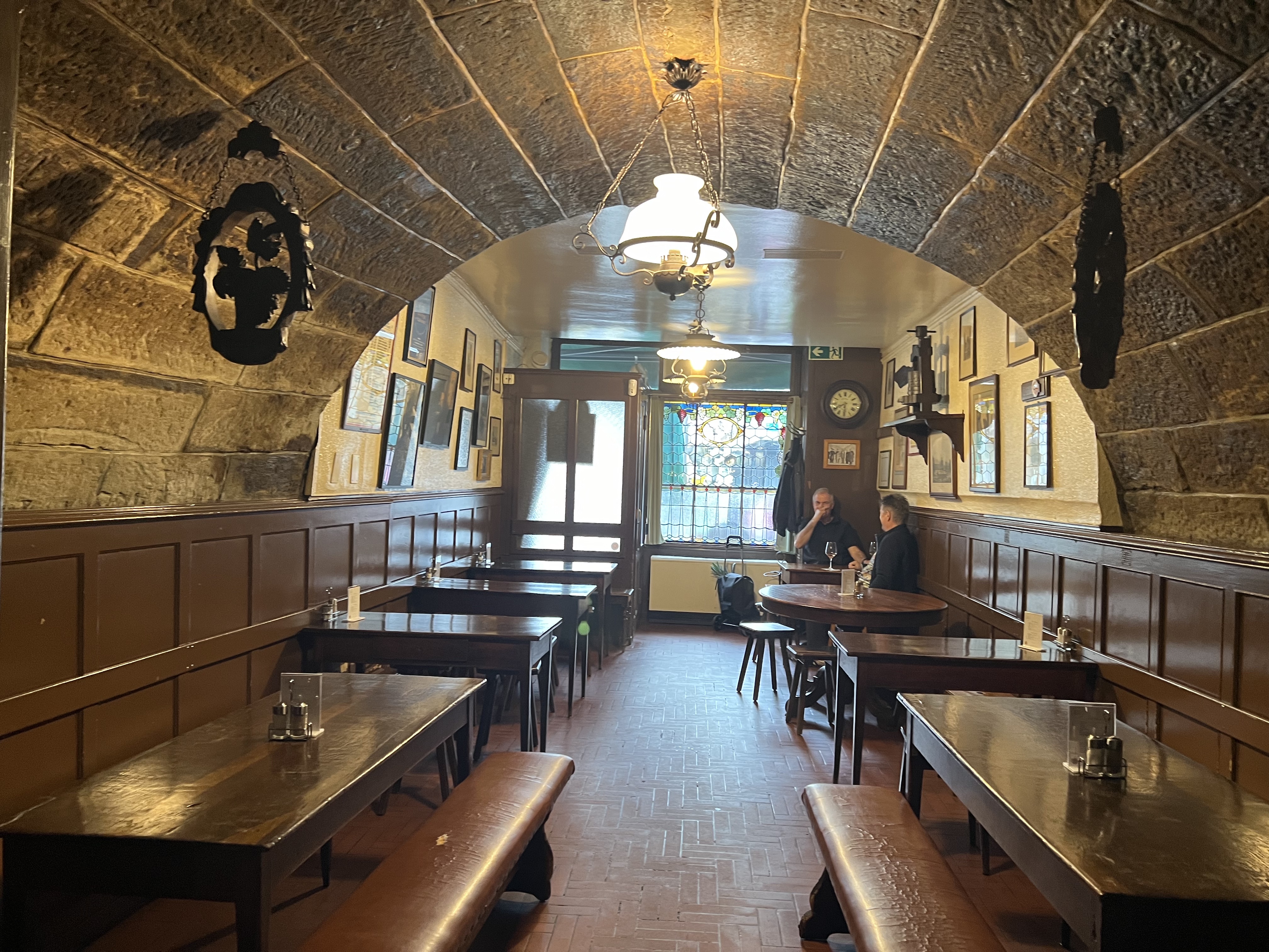 The vaulted stone interior of Pinte Besson, Lausanne's oldest restaurant